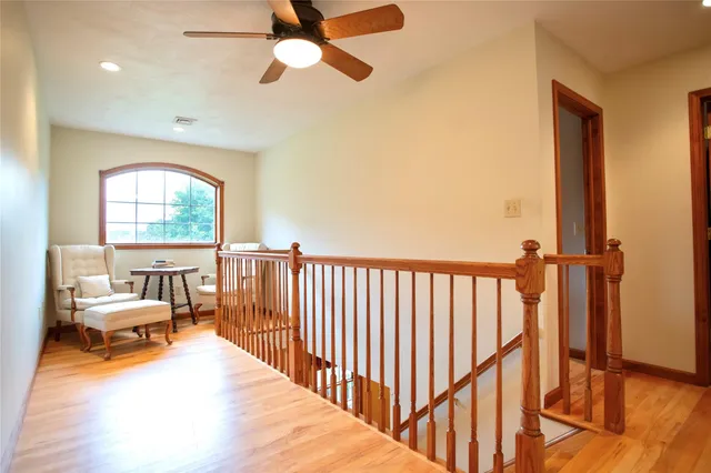 a view of a bedroom with furniture window and wooden floor