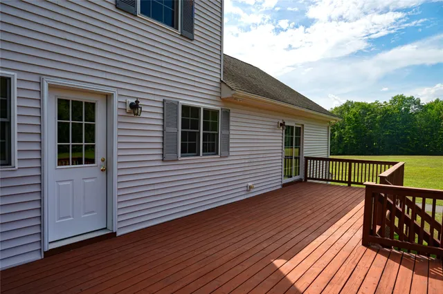 a view of a house with wooden deck