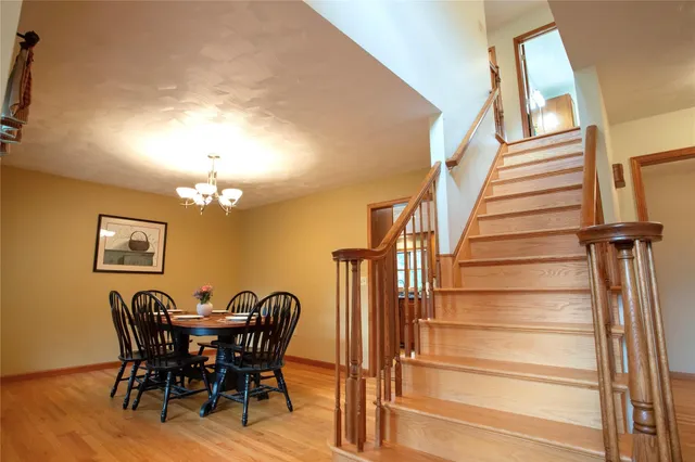 a view of a dining room with furniture and chandelier