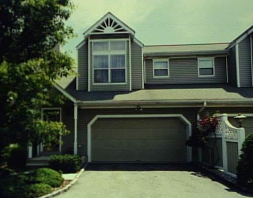 162 Colonial Road, Unit 11 Stamford, CT 06906 - Photo 1 of 1 a front view of a house with a yard