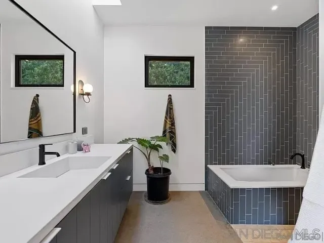 a bathroom with a double vanity sink and a bathtub
