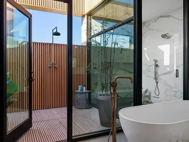 a bathroom with a bathtub and shower