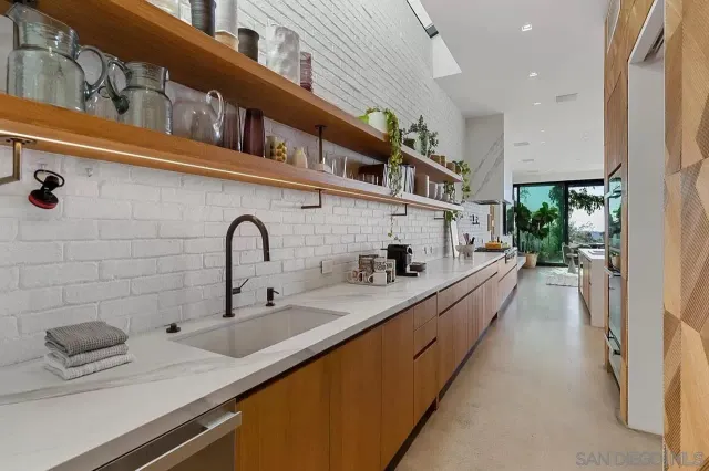 a kitchen with stainless steel appliances a sink a stove and a refrigerator