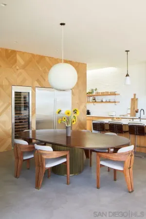 a large kitchen with kitchen island a large window in it