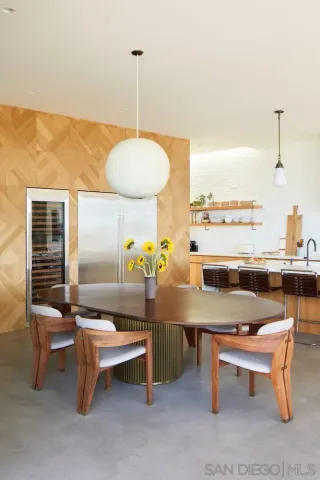 a large kitchen with kitchen island a large window in it