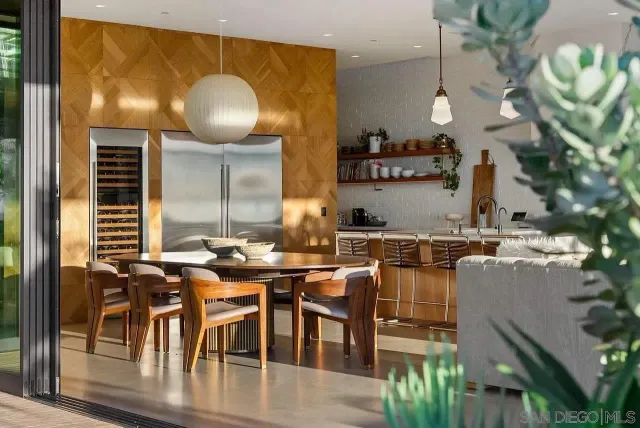 a kitchen with stainless steel appliances granite countertop a stove and a view of living room