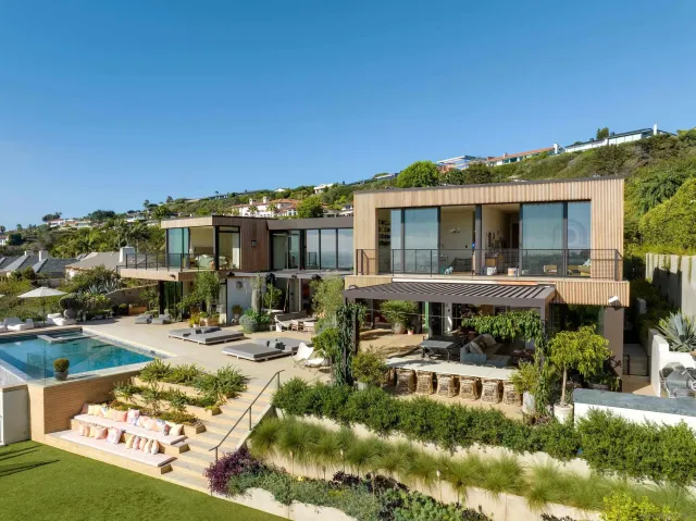 a view of a house with swimming pool and sitting area