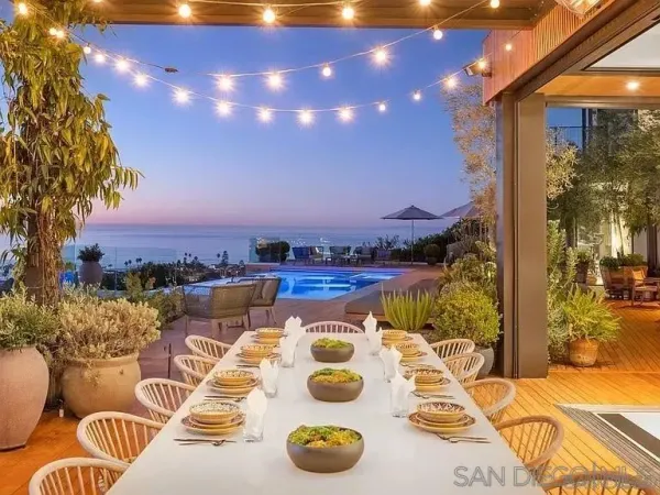 a view of a balcony with chairs and potted plants