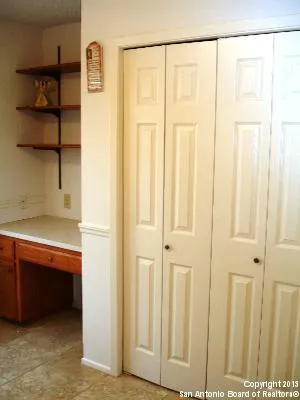 a bed sitting in a bedroom next to a lamp