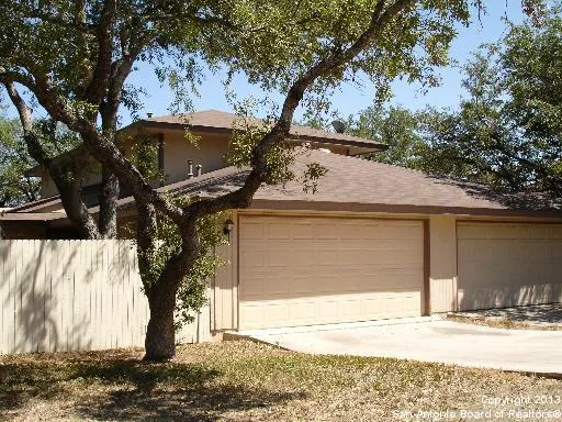 front view of a house with a tree