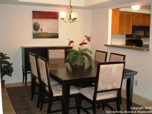 a view of a dining room with furniture and a potted plant