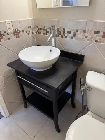 a bathroom with a white toilet and a bath tub
