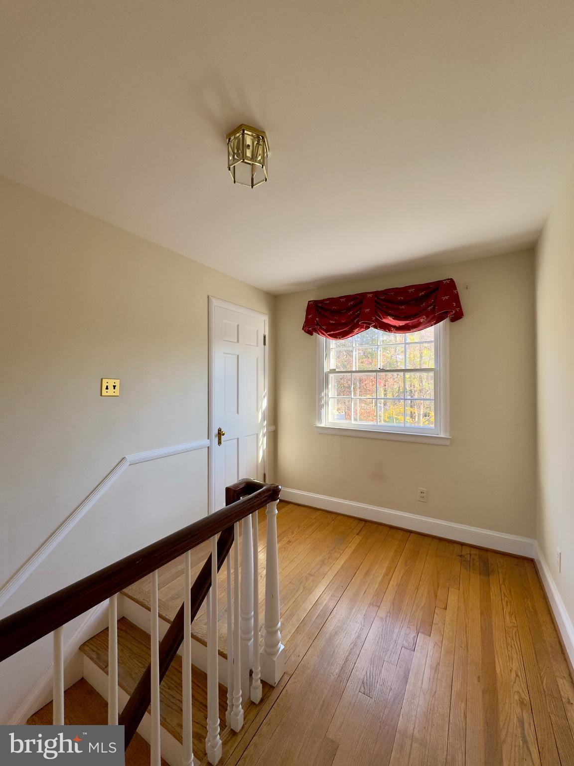 5113 North Charles Street Baltimore, MD 21210 - Photo 14 of 34 a view of an empty room with wooden floor and a window