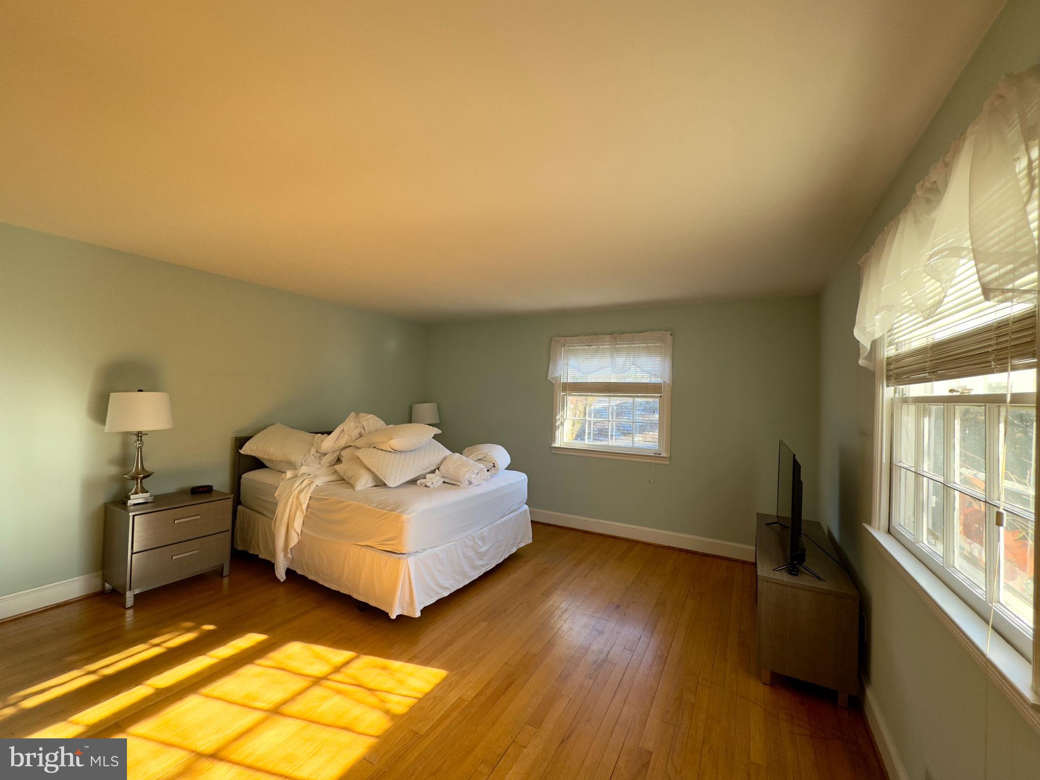 5113 North Charles Street Baltimore, MD 21210 - Photo 16 of 34 a bedroom with a bed and a window