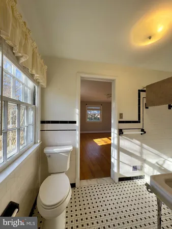 a bathroom with a toilet a sink and a shower