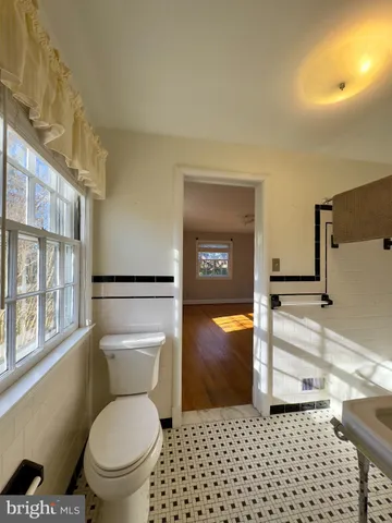 a bathroom with a toilet a sink and a shower