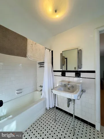 a bathroom with a sink a toilet and bathtub