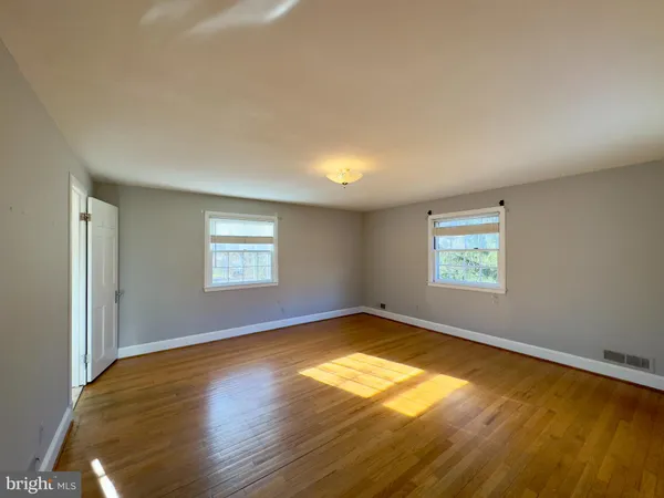 a view of a room with wooden floor and window