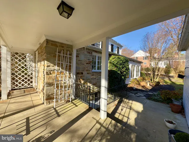 a view of a balcony with chairs and potted plants