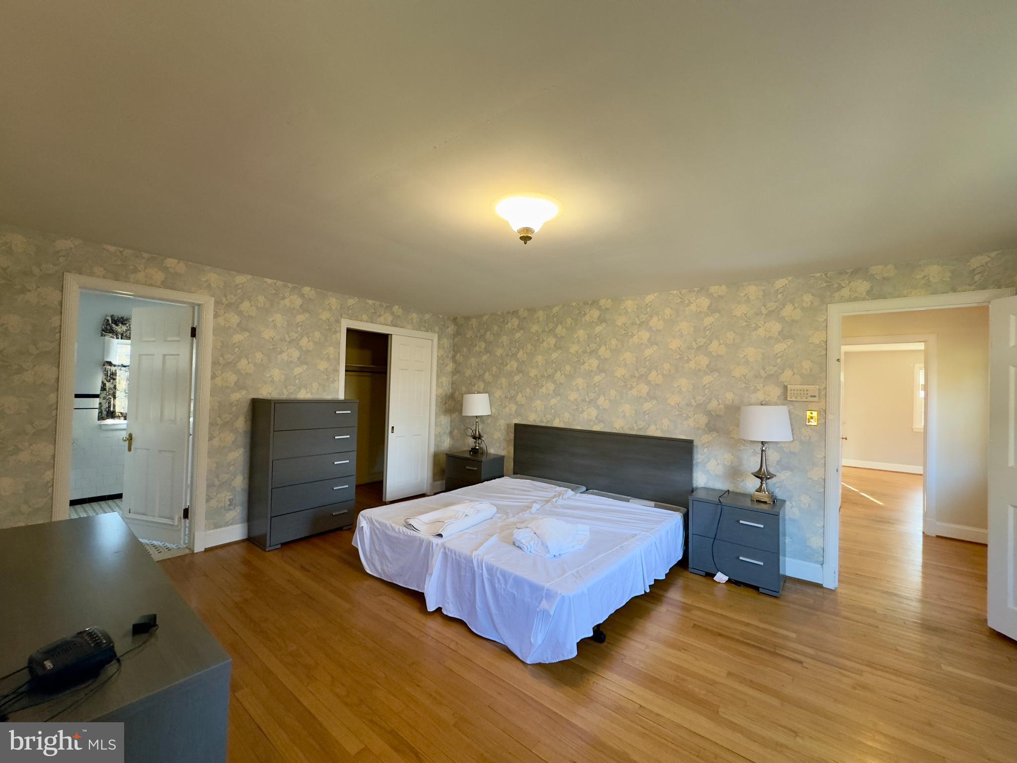 5113 North Charles Street Baltimore, MD 21210 - Photo 22 of 34 a bedroom with a bed and wooden floor