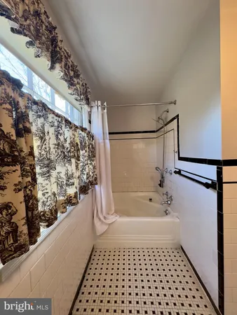 a bathroom with a bathtub and shower