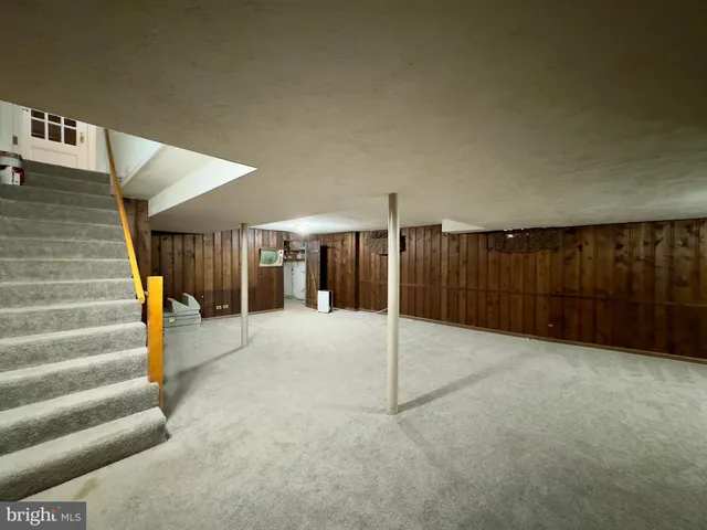 a view of an empty room with stairs