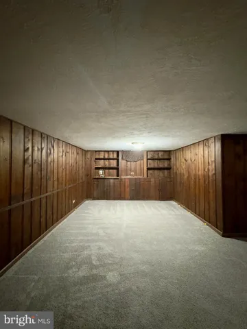 an empty room with staircase and floor to ceiling window