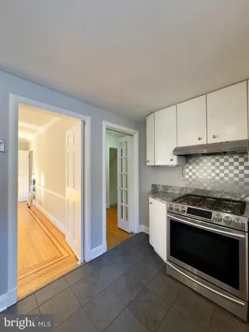 a kitchen with stainless steel appliances granite countertop a stove and a refrigerator