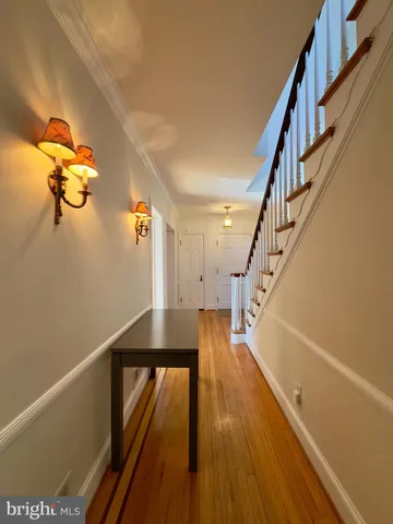 a view of entryway and hall with wooden floor