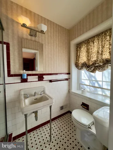 a bathroom with a sink toilet and mirror