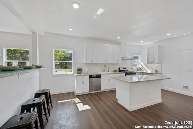 a kitchen with a sink cabinets and window