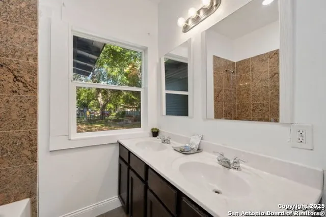 a bathroom with a sink double vanity and a mirror
