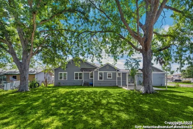 a front view of a house with yard and green space