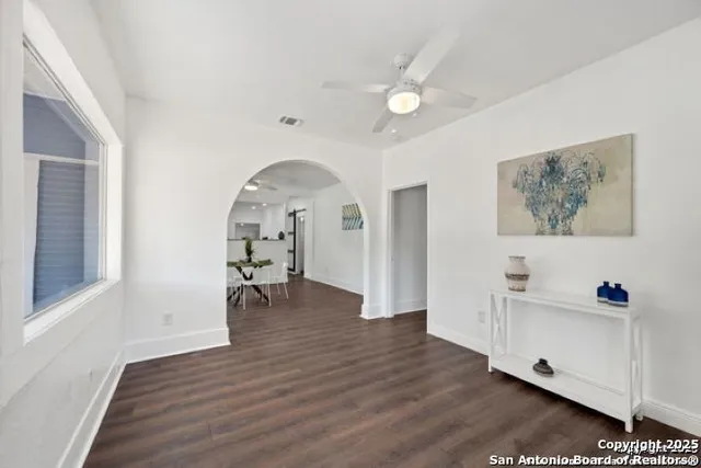 a view of dining room with wooden floor and furniture