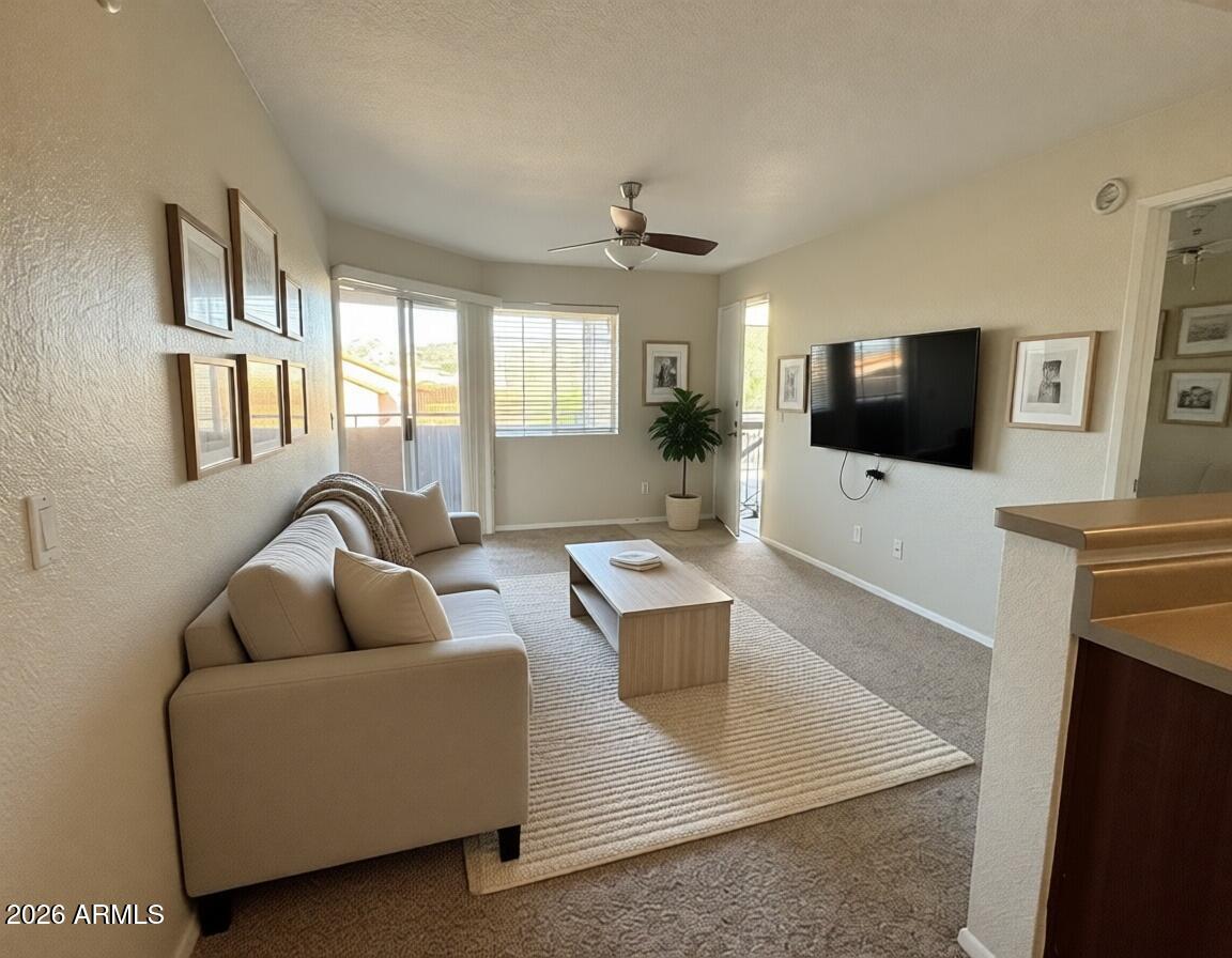 1720 East Thunderbird Road, Unit 2068 Phoenix, AZ 85022 - Photo 2 of 10 a living room with furniture and a flat screen tv