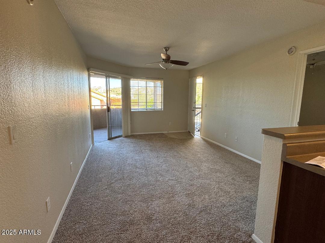 1720 East Thunderbird Road, Unit 2068 Phoenix, AZ 85022 - Photo 3 of 10 an empty room with windows and fireplace
