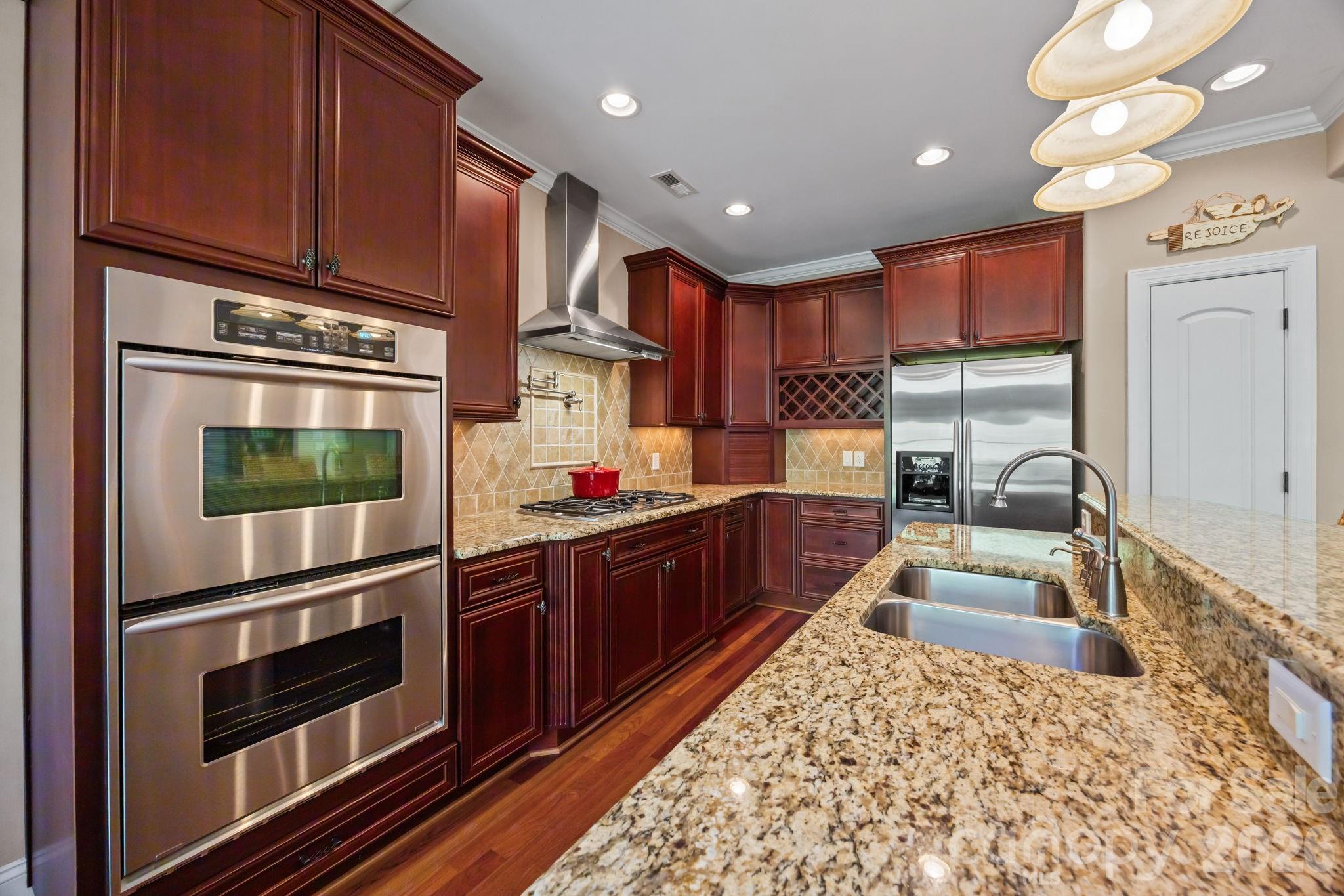 120 Laurel Ridge Drive Statesville, NC 28677 - Photo 13 of 48 a kitchen with stainless steel appliances granite countertop a refrigerator stove and sink