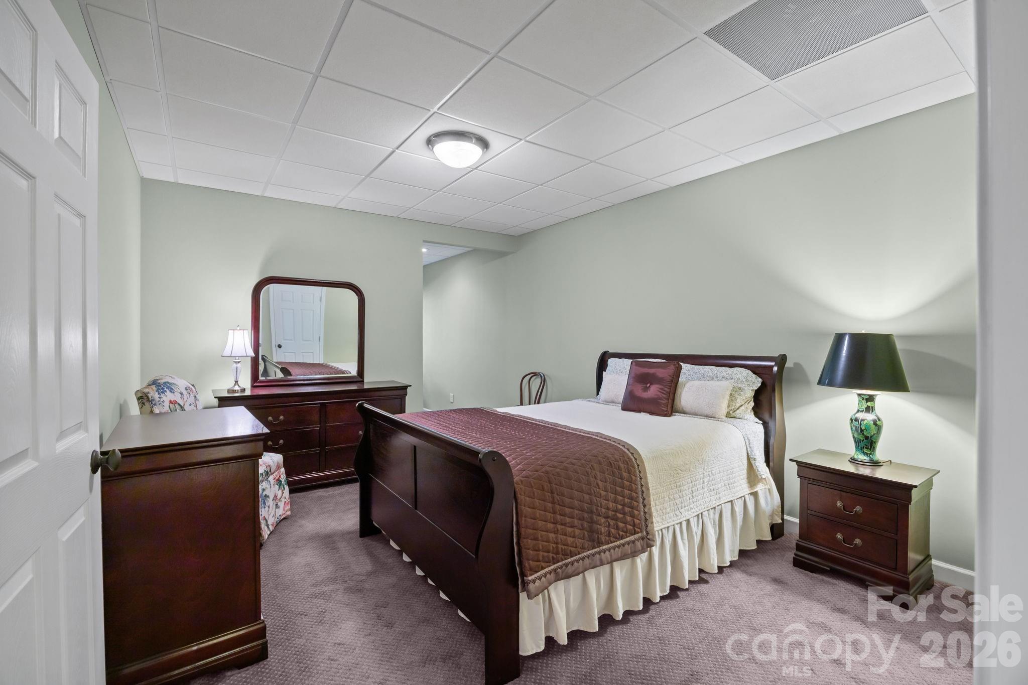 120 Laurel Ridge Drive Statesville, NC 28677 - Photo 27 of 48 a bedroom with a bed and a chandelier