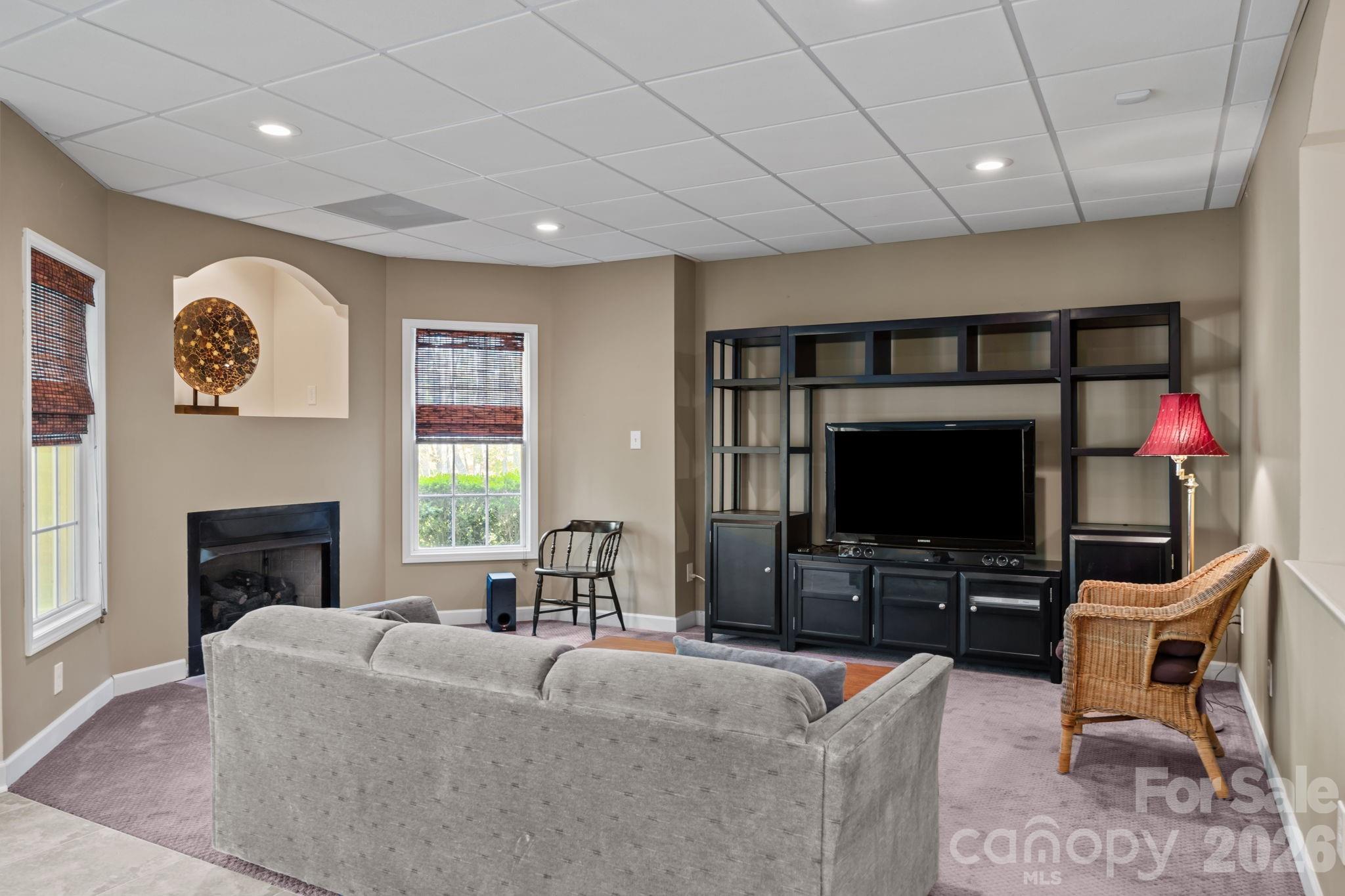 120 Laurel Ridge Drive Statesville, NC 28677 - Photo 29 of 48 a living room with furniture a flat screen tv and a fireplace