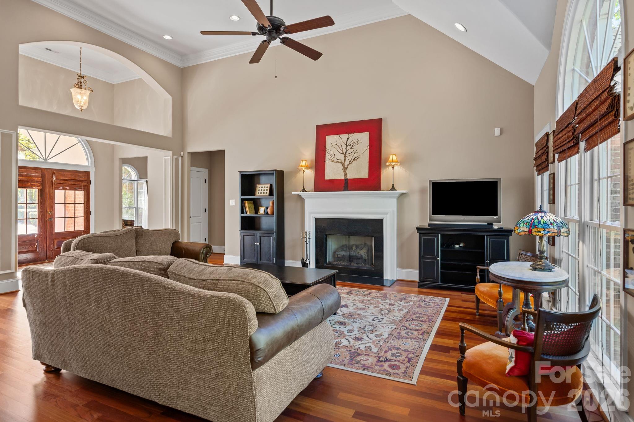 120 Laurel Ridge Drive Statesville, NC 28677 - Photo 8 of 48 a living room with furniture a flat screen tv and a fireplace