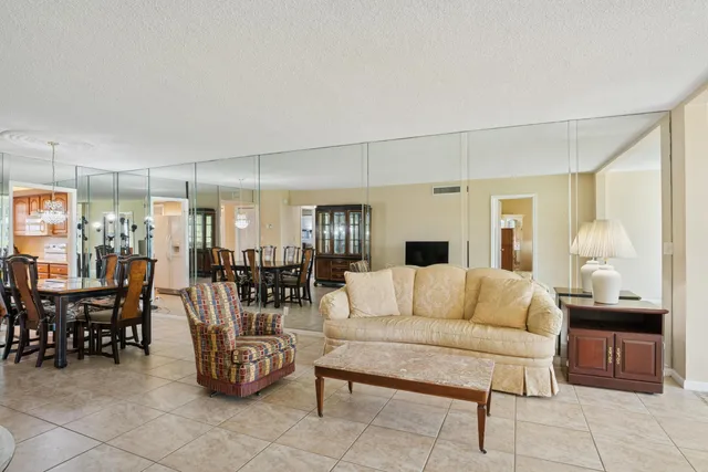 a living room with furniture and a view of kitchen