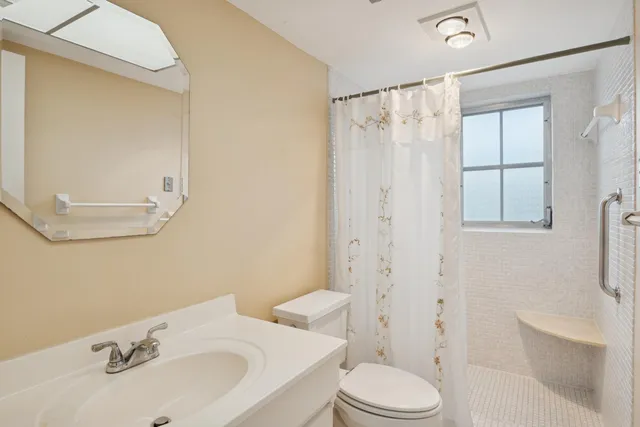 a bathroom with a sink toilet and shower