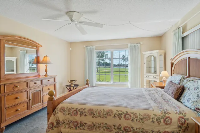 a bed sitting in a bedroom next to a window with dresser