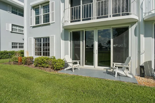 a garden with a bench in front of house