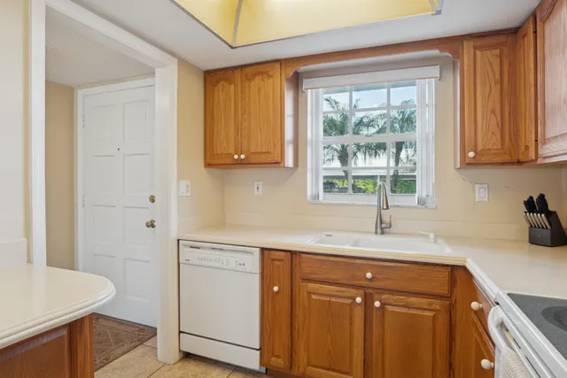 a kitchen with a sink cabinets and window