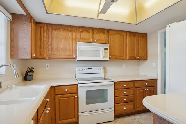 a kitchen with stainless steel appliances granite countertop a sink a stove and cabinets