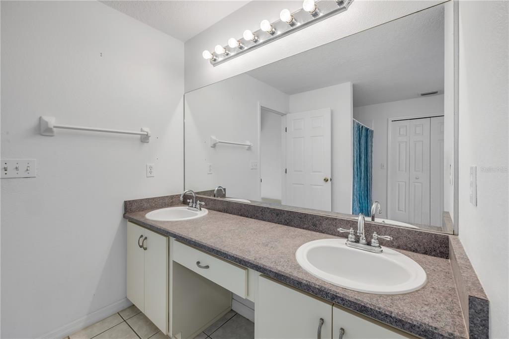 192 Azalea Road Edgewater, FL 32141 - Photo 19 of 94 a bathroom with a granite countertop sink and a mirror