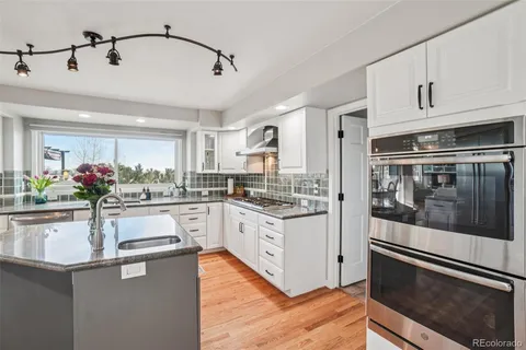 a bathroom with a tub a sink and glass door shower