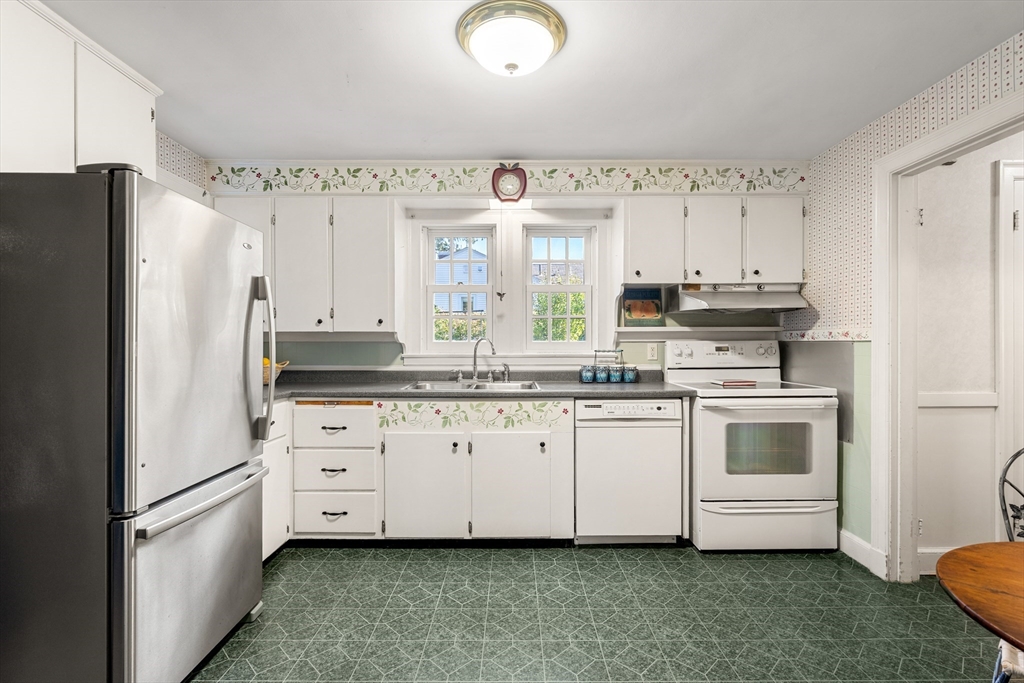 62 Longview Drive Marblehead, MA 01945 - Photo 13 of 42 a kitchen with granite countertop white cabinets and white appliances