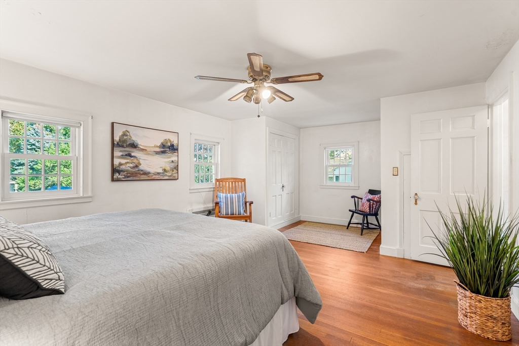 62 Longview Drive Marblehead, MA 01945 - Photo 22 of 42 a bedroom with a bed and a chandelier